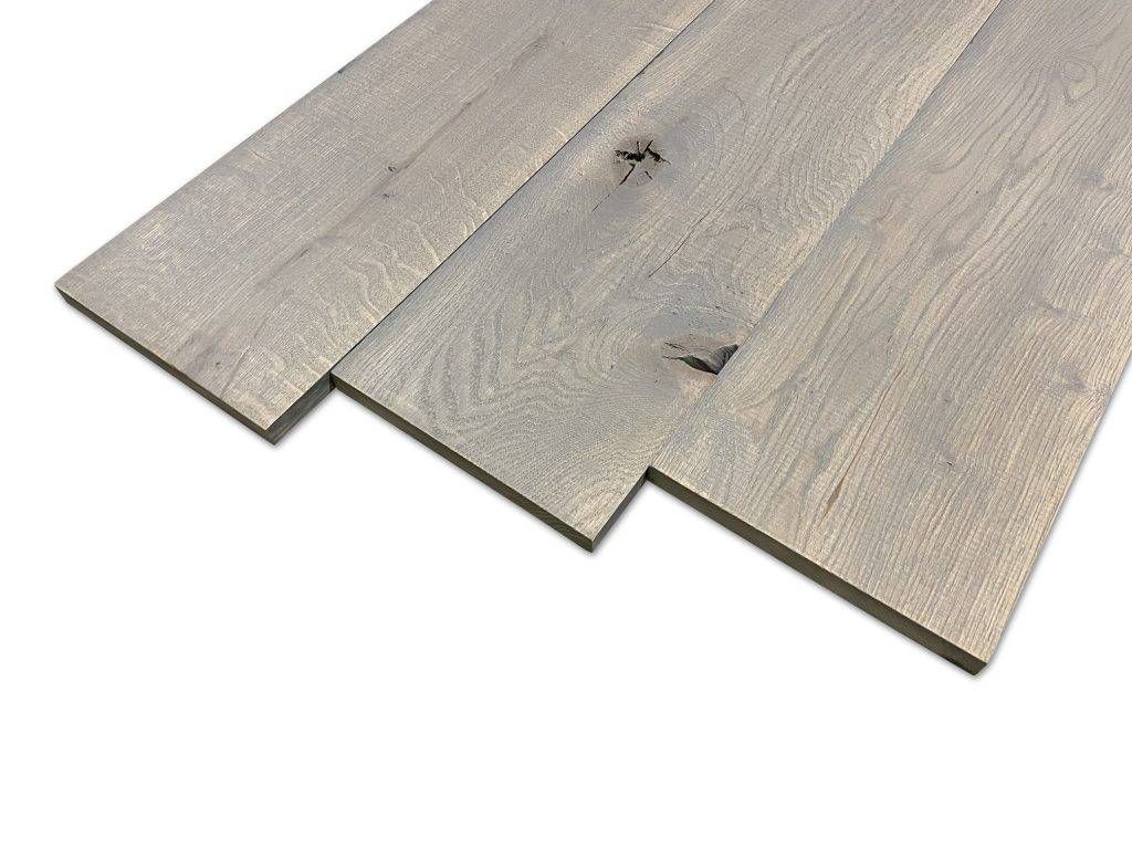 Massief eiken plank grey wash. Massief eiken planken met een rustieke uitstraling. Bij Woodstyles volop uit voorraad te verkrijgen in drie verschillende kleuren. Grey wash, middle grey en carbon black. Kies zelf uw favoriete kleur. Met een afmeting van 19 mm dik, 19,5 cm breed en 250 cm lang, zijn dit ideale planken om op allerlei manieren te kunnen gebruiken. Woodstyles biedt u deze planken ook voor een zeer scherpe prijs aan!